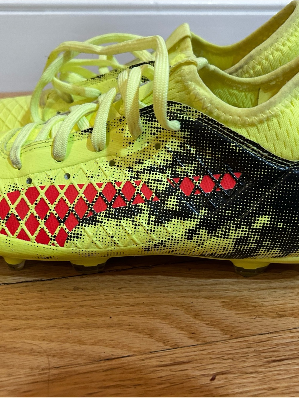 Puma Kids Neon Yellow Soccer Cleats with Black and Red Accents